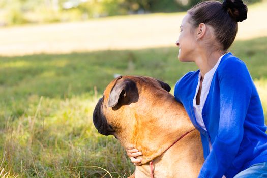 teen girl with the dog Bullmastiff outdoors