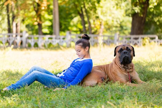 teen girl with the dog Bullmastiff outdoors