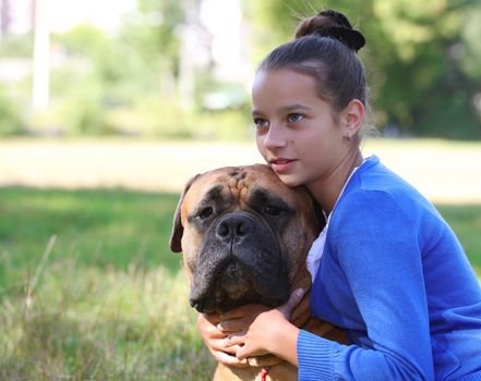 teen girl with the dog Bullmastiff outdoors