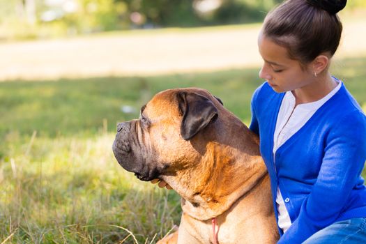 teen girl with the dog Bullmastiff outdoors