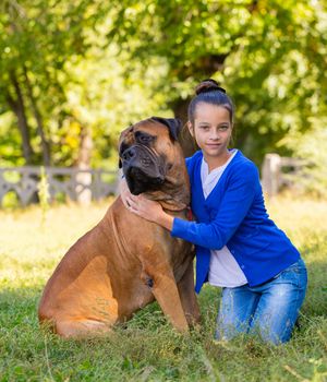 teen girl with the dog Bullmastiff outdoors