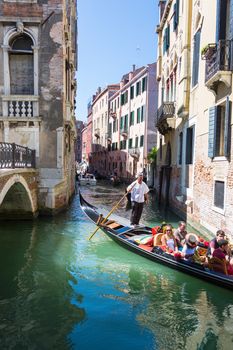 VENICE, ITALY - AUGUST 7 2016: Tourists floating in gondola, Venice, Italy