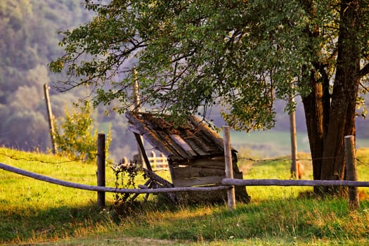 September rural scene in Carpathian mountains. Authentic village and fence