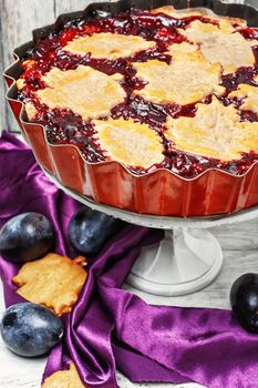 Autumn pie with plum decorated cakes in the form of leaflets