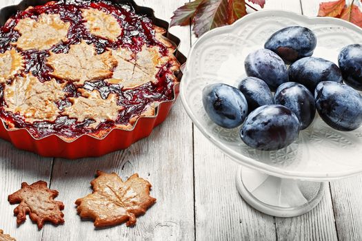 Autumn pie with plum decorated cakes in the form of leaflets