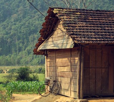 Old wooden house and bicycle at Quang Binh village, Vietnam, peaceful scene of countryside among jungle so wonderful and beautiful