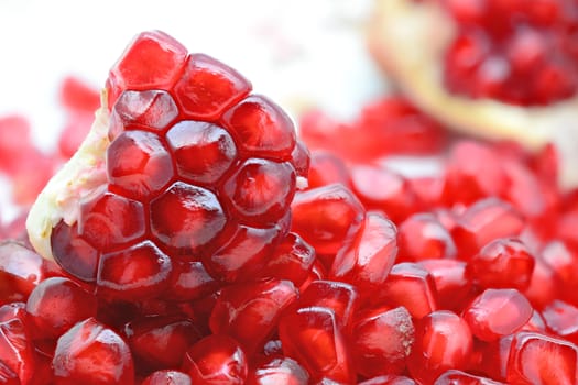 Fresh peeled pomegranates and red pomegranate seeds