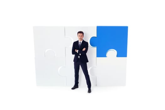 Portrait of business man and puzzle isolated on white background