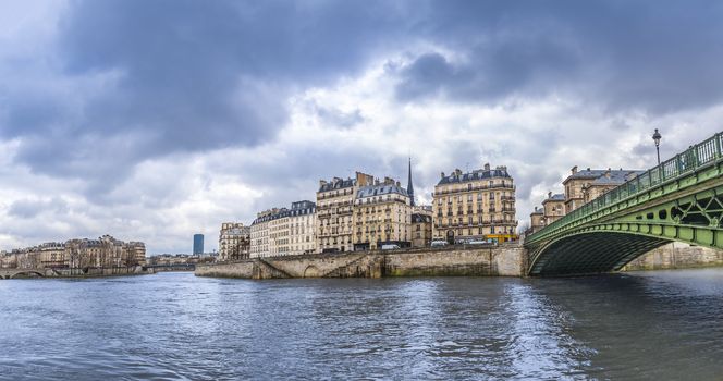 Panorama with the river Seine, its bridges and the Parisian buildings on its shore. Picture taken in Paris, France.