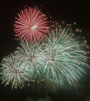 Brightly colorful fireworks and salute of various colors in the night sky background