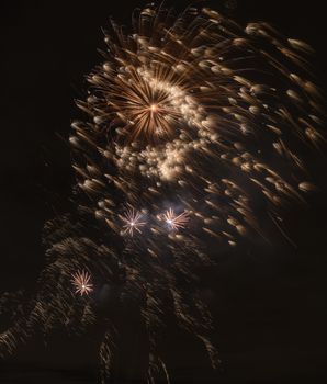 Brightly colorful fireworks and salute of various colors in the night sky background