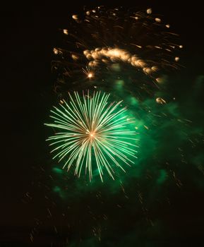 Brightly colorful fireworks and salute of various colors in the night sky background