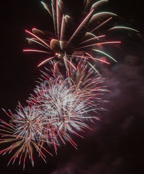 Brightly colorful fireworks and salute of various colors in the night sky background