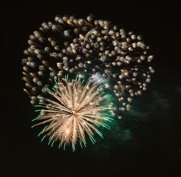 Brightly colorful fireworks and salute of various colors in the night sky background