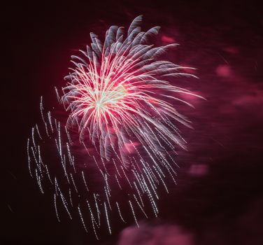 Brightly colorful fireworks and salute of various colors in the night sky background