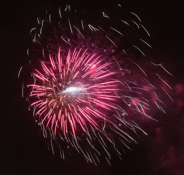 Brightly colorful fireworks and salute of various colors in the night sky background