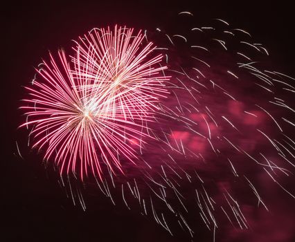 Brightly colorful fireworks and salute of various colors in the night sky background