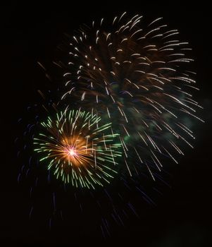 Brightly colorful fireworks and salute of various colors in the night sky background