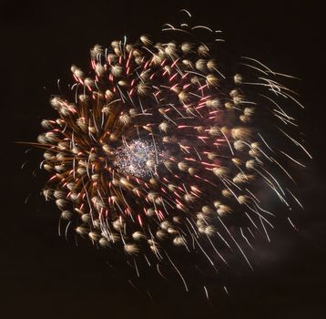 Brightly colorful fireworks and salute of various colors in the night sky background