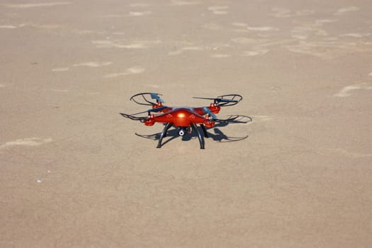 orange drone on the sand