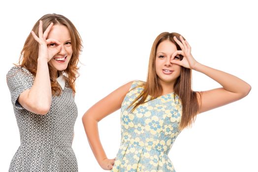 Two young beautiful girls with funny grimace on white background