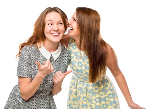 beautiful young girlfriends gossiping over white background