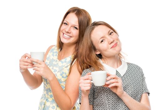 Horizontal portrait of two women with cups of coffee on a white background