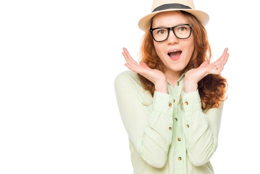 Surprised girl in the hat on a white background