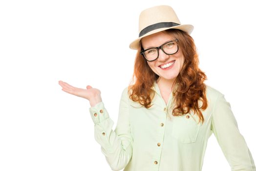 red-haired girl in a hat keeps on hand something on a white background
