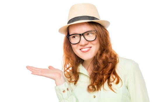 red-haired girl in a hat keeps on hand something on a white background