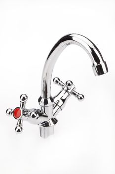 Metal chromium-plated water mixer on an isolated background