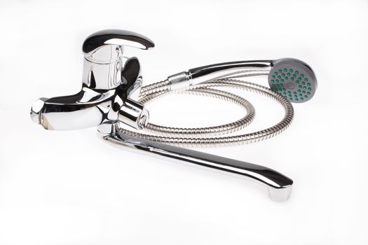 Metal chromium-plated water mixer on an isolated background
