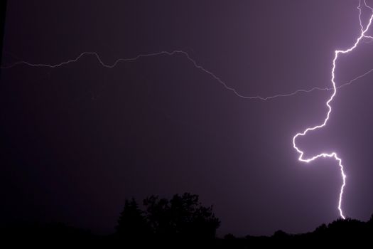 Lightning bolt of lightning at night in the summer.