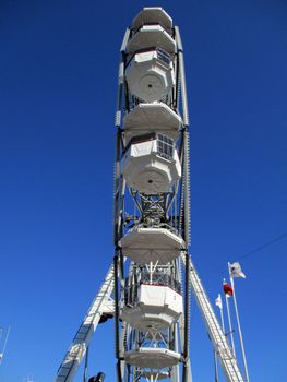 White Ferris wheel on the waterfront of the port of La Spezia