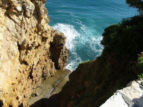 view from above of the waves on the rocks