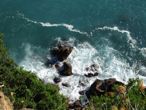 view from above of the waves on the rocks