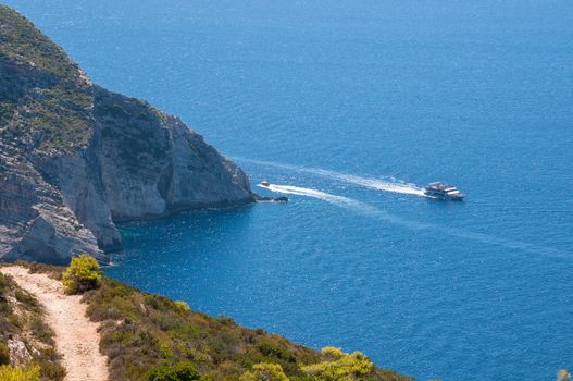 Tourist ship at the cliff coast of Zakynthos Island, Greece