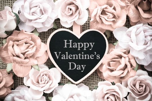 Happy valentine's day wooden tag with roses on sack background vintage style.