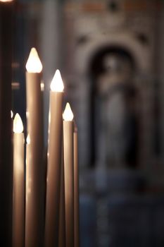 lighted candles in the cathedral of Pisa, Tuscany, Italy