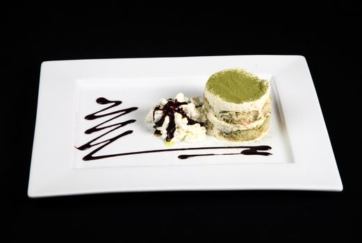 sweet green tea in white plate on a black background