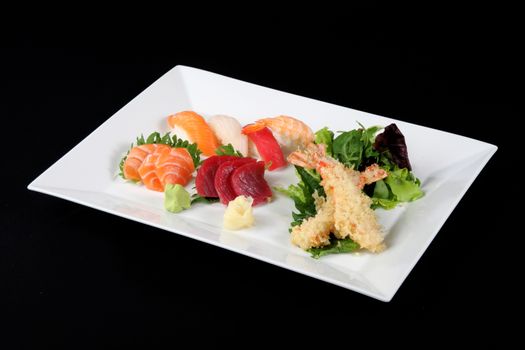 menu of sushi, sashimi and fried with vegetables in white plate on a black background