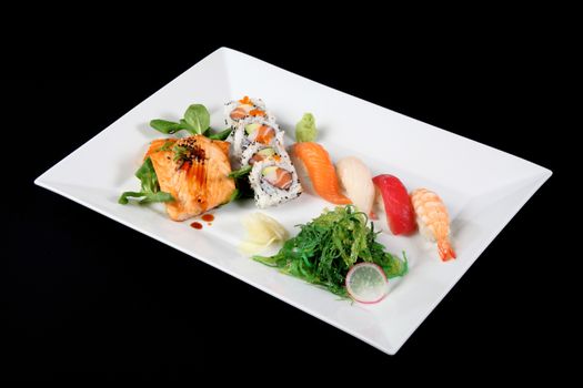 menu of sushi and grilled fish with vegetables in white dish, on black background