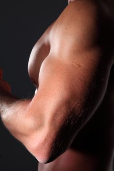 seminude muscular man black background