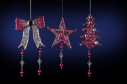 Christmas decorations to hang on the Christmas tree on a black and blue background