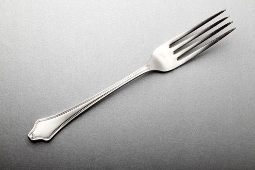 elegant steel fork engraved on the handle, on white silver