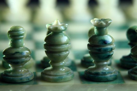 chessboard and alabaster chess on a black background