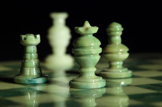 chessboard and alabaster chess on a black background