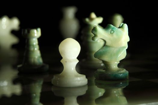 chessboard and alabaster chess on a black background