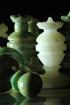 chessboard and alabaster chess on a black background