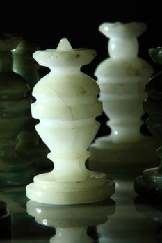 chessboard and alabaster chess on a black background